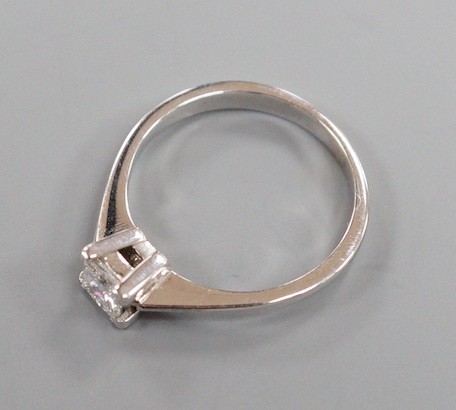 A modern 750 white metal and solitaire princes cut diamond set ring, size L/M, gross weight 2.6 grams